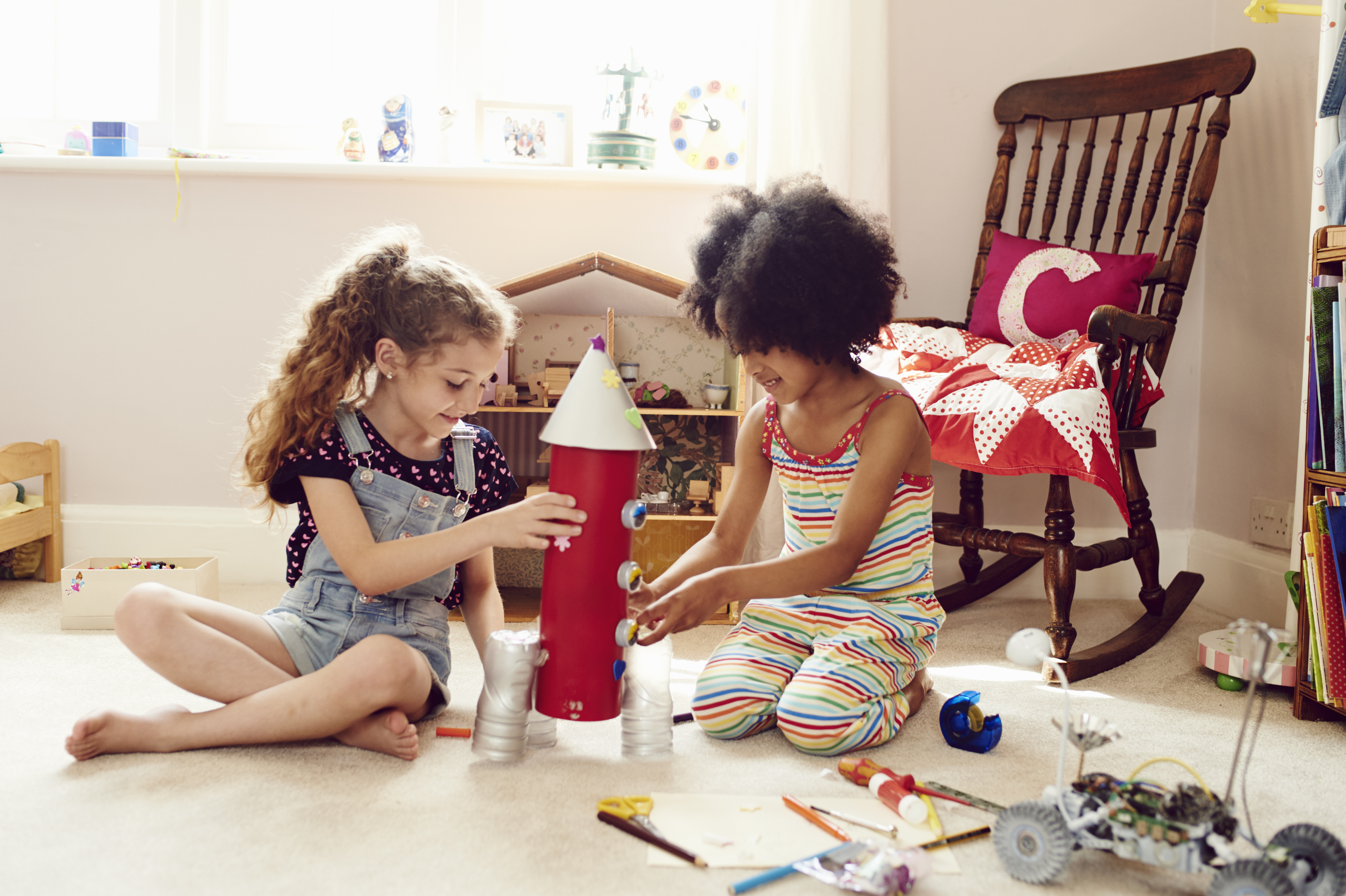 Two children working together to make things | Source: Getty Images