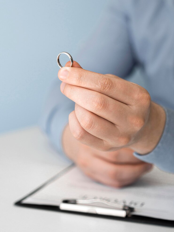 A person looking at their wedding ring | Source: FreePik