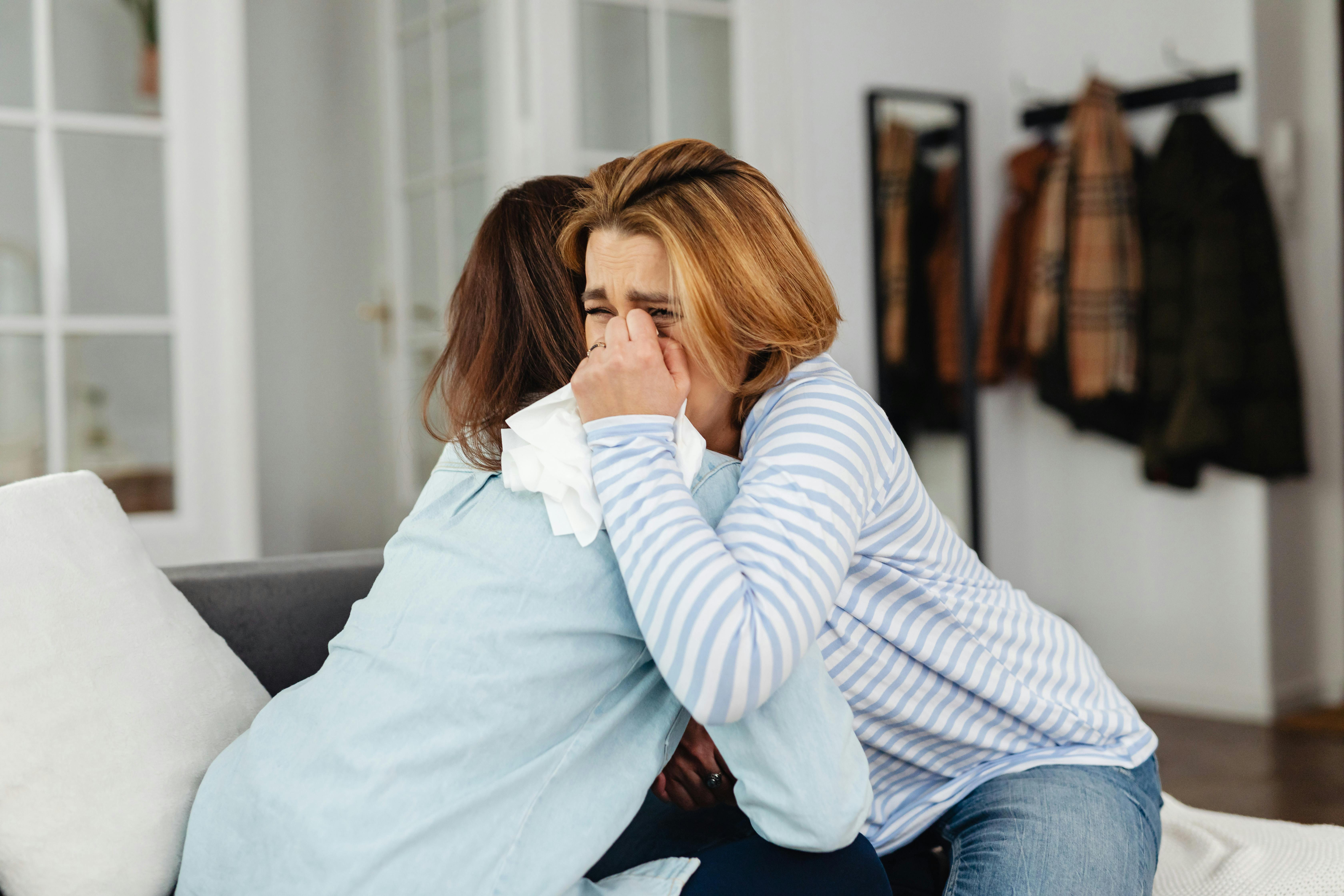 A woman crying to another person | Source: Pexels