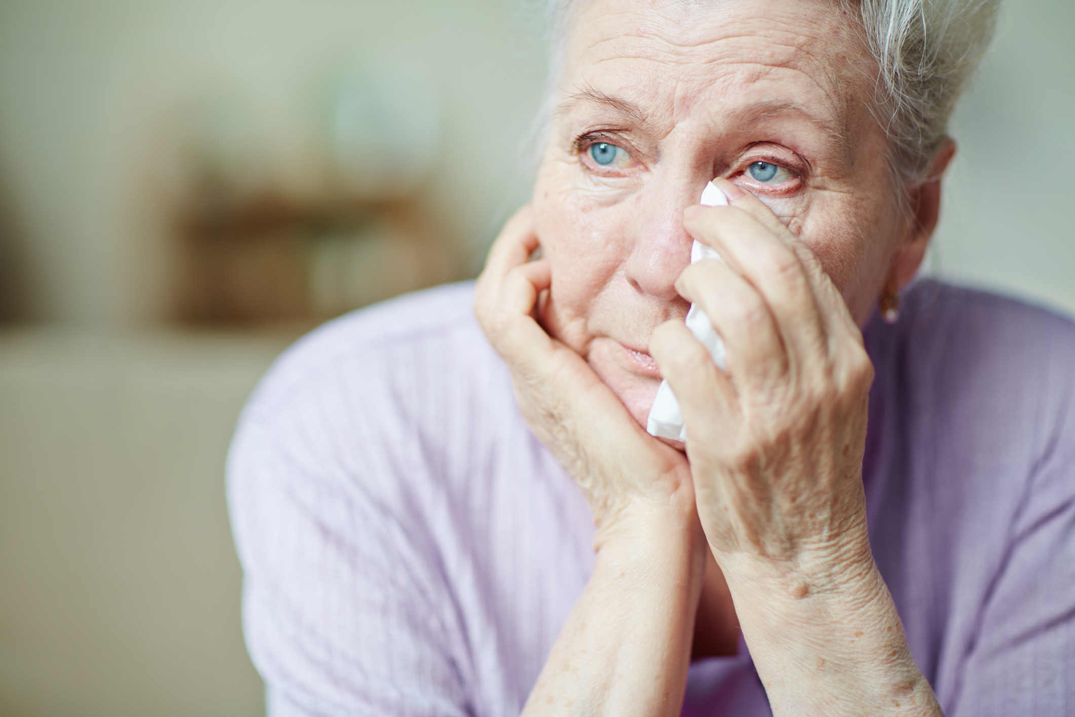 An upset woman wiping away tears | Source: Getty Images