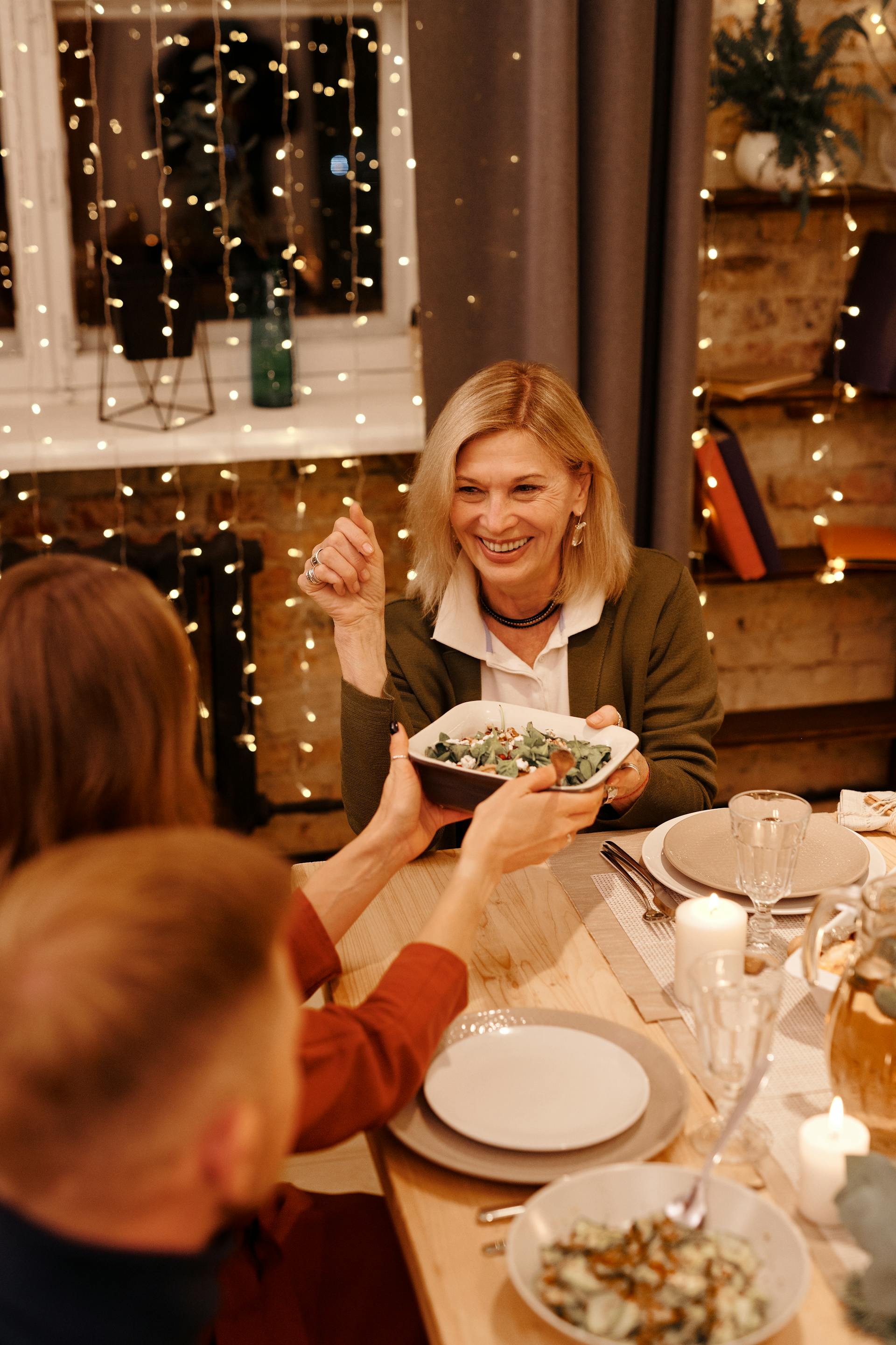 A person passing food around a table | Source: Pexels