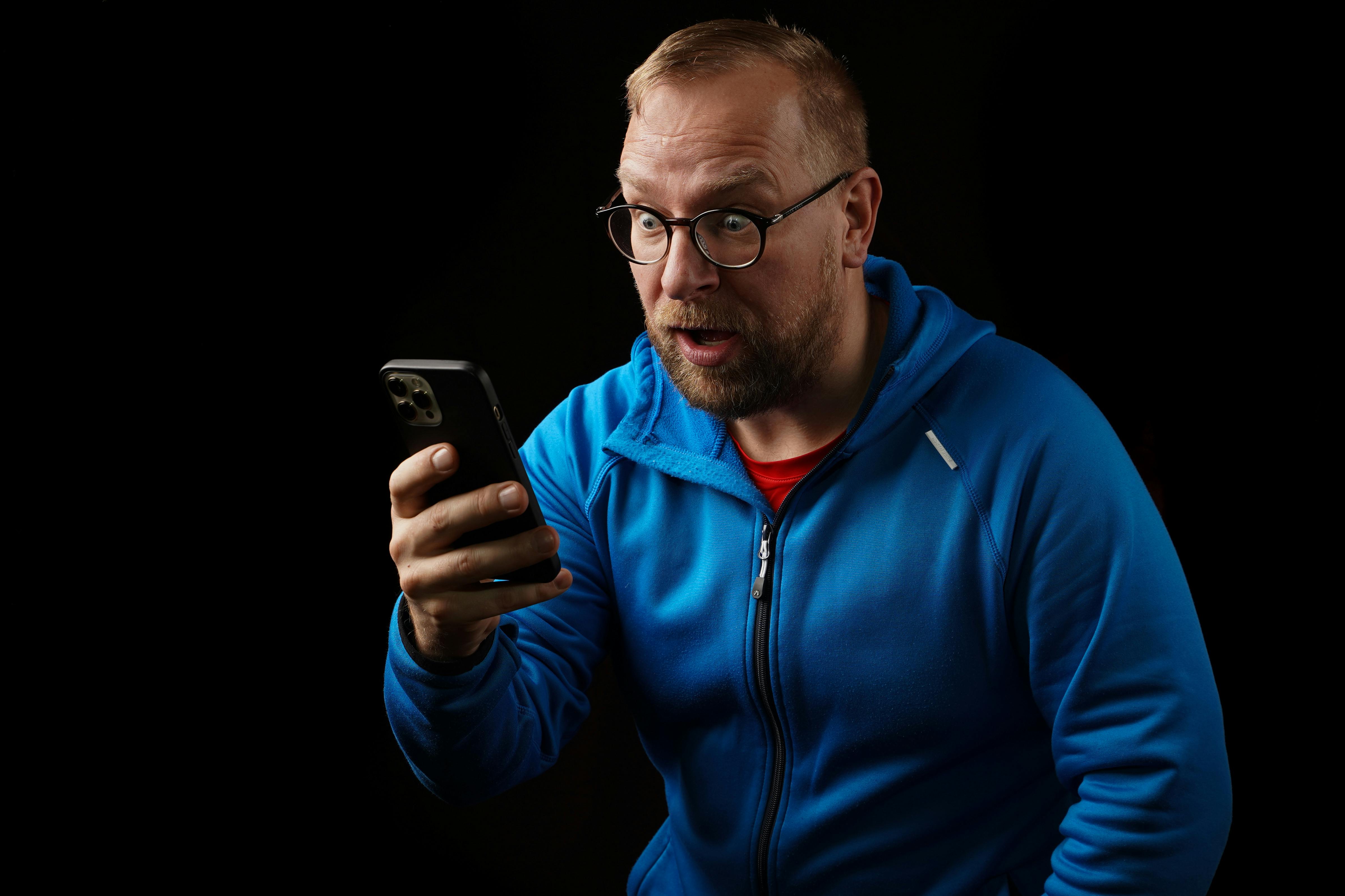 A distressed man looking at his phone | Source: Pexels