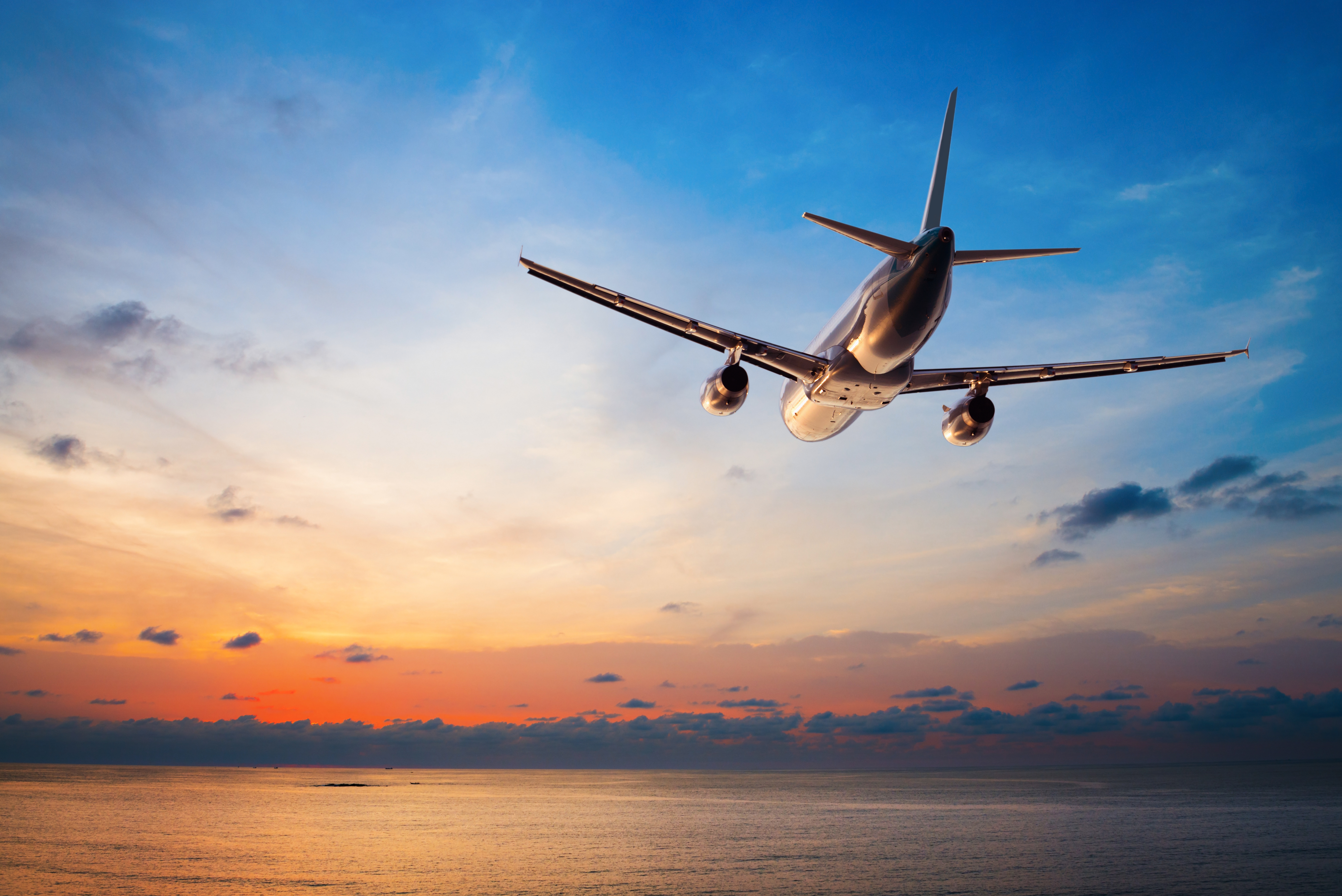 An airplane flying against a sunset background | Source: Shutterstock