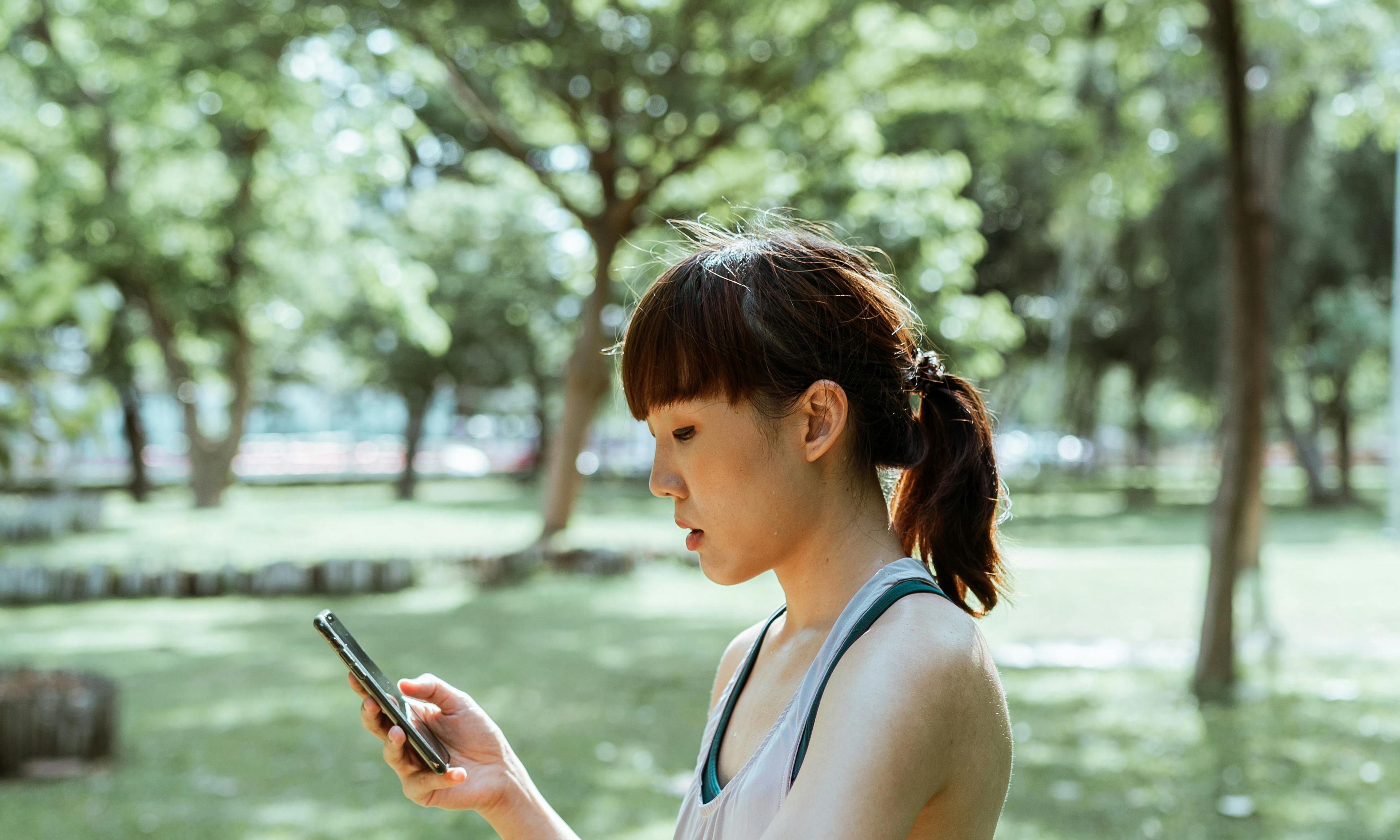 A woman looks at her cell phone | Source: Pexels