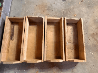 Four wooden boxes with grooves cut into the long sides of interior – what are these?