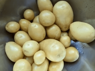 Is it essential to wash potatoes before peeling?